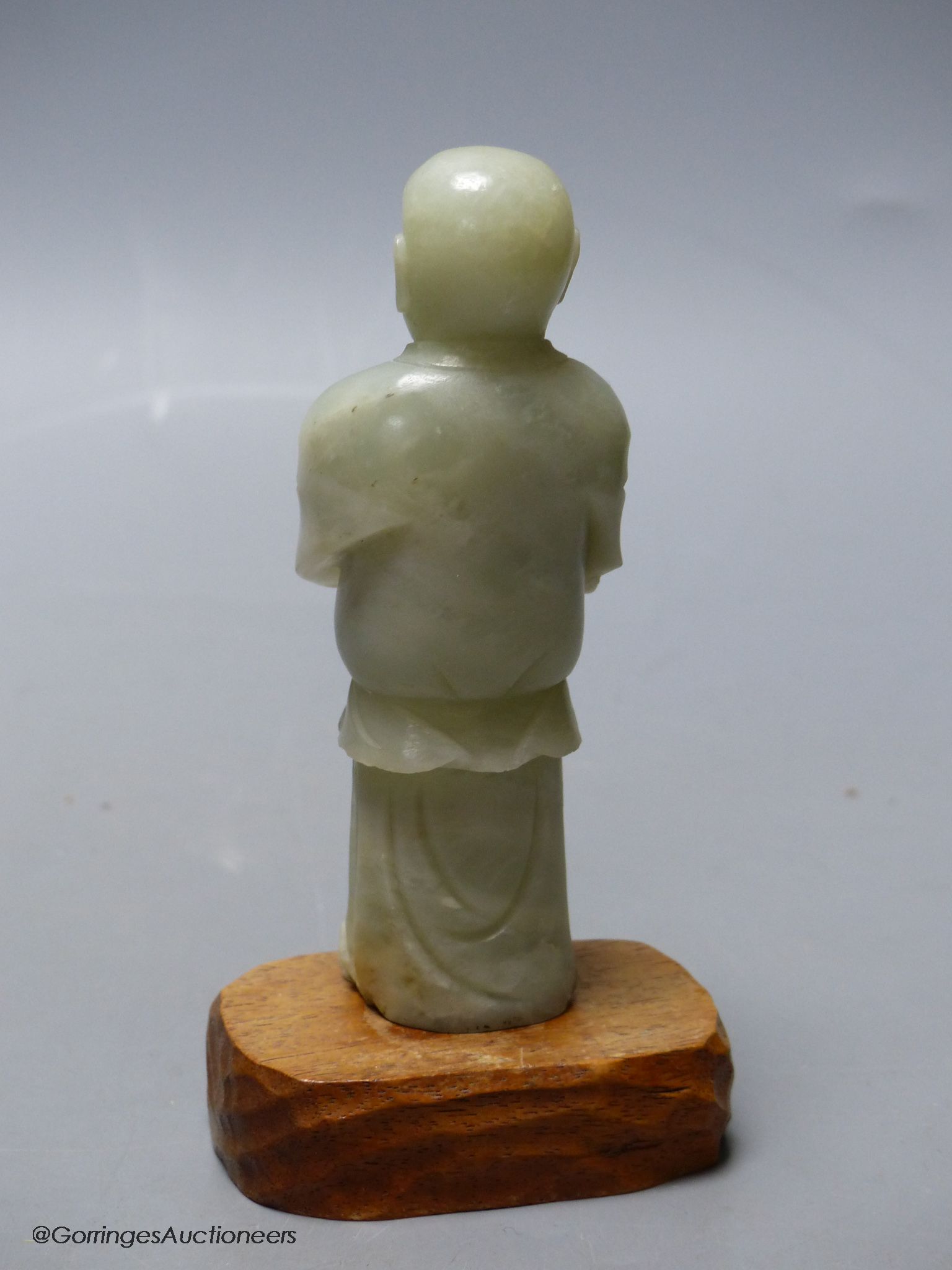A Chinese celadon jade figure of a priest